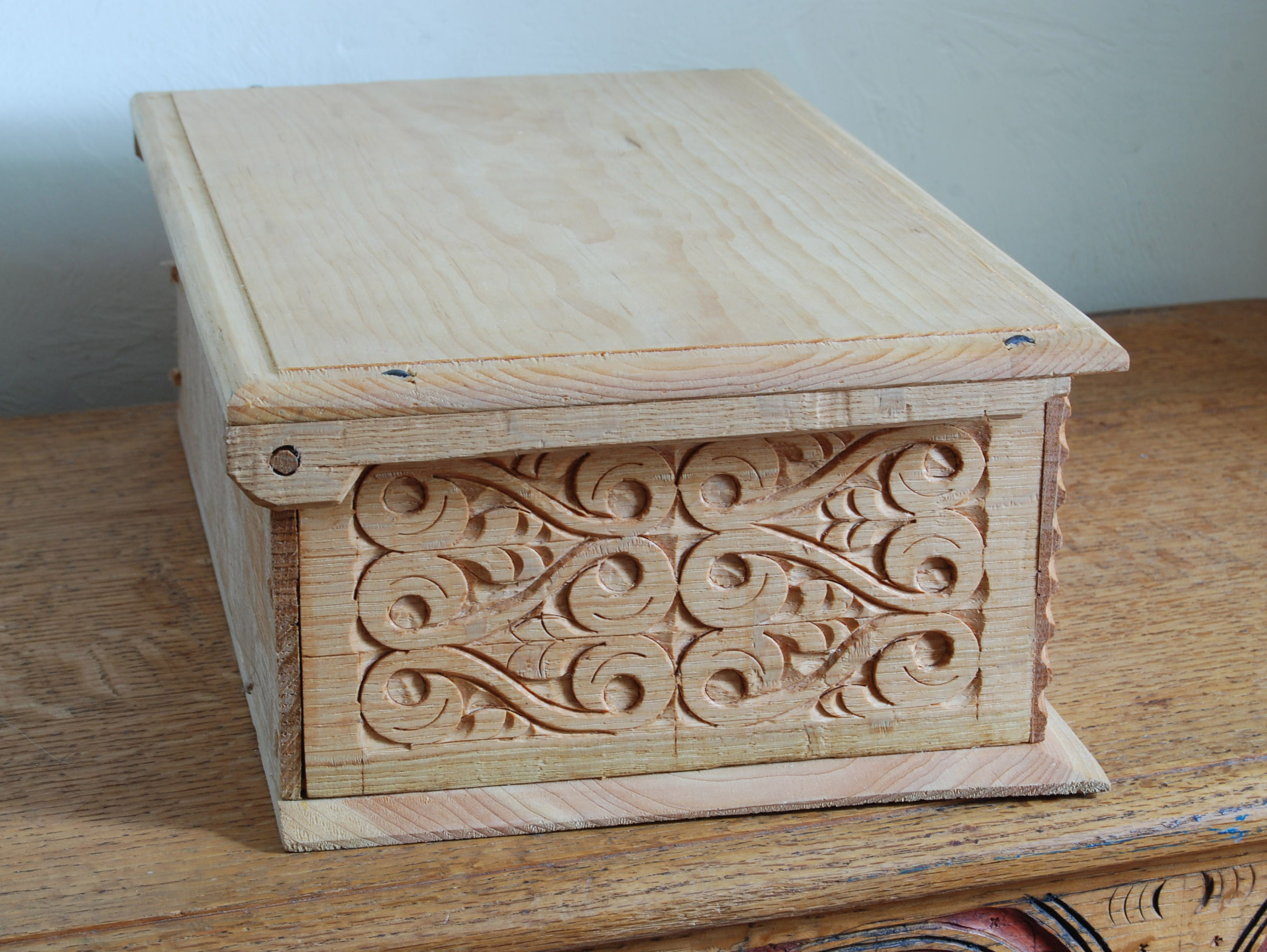 small wooden box with hinged lid